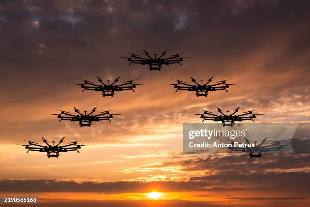 group of drones against sunset sky - unmanned aerial vehicle stock pictures, royalty-free photos & images