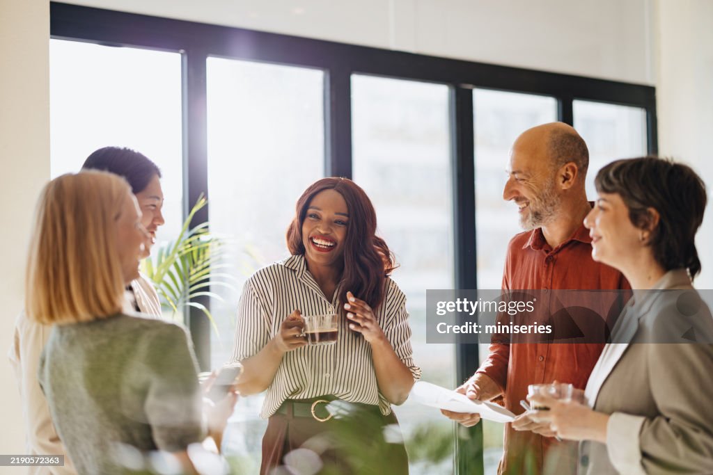 Diverse Team Engages in a Friendly Business Discussion in Modern Office Setting