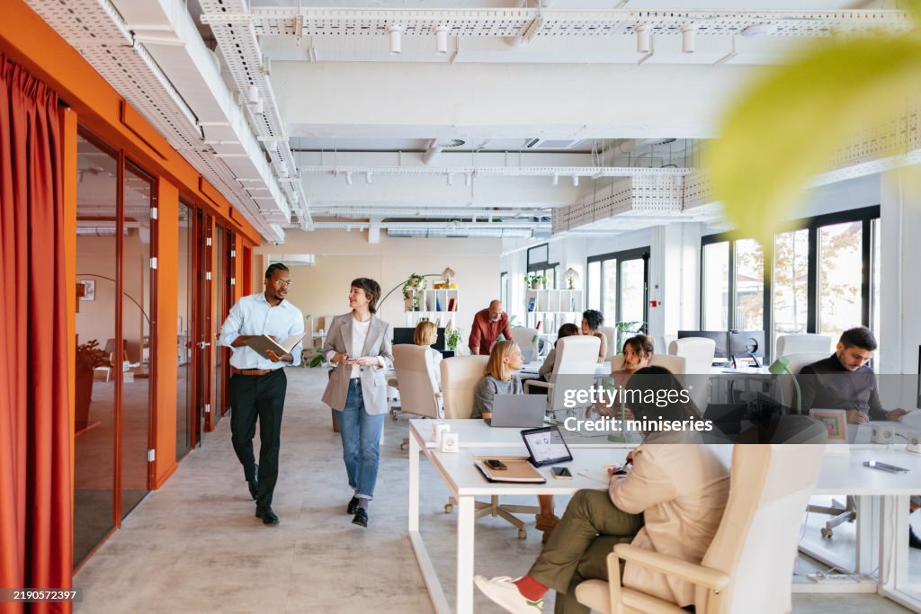 Modern Collaborative Office Space with Diverse Professionals Working in a Co-Working Environment