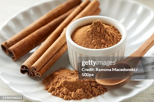 Cinnamon sticks and cinnamon powder isolated on a white background Cinnamon sticks and cinnamon powder isolated on a white background