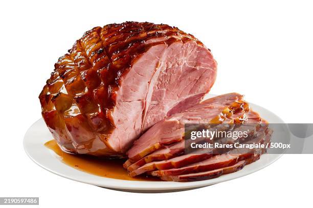 a baked ham with a glaze on top - ham stockfoto's en -beelden