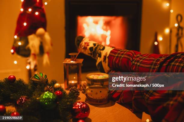 resting by the christmas fireplace sitting under the blanket,relaxes by warm fire - fire under her skin stock pictures, royalty-free photos & images