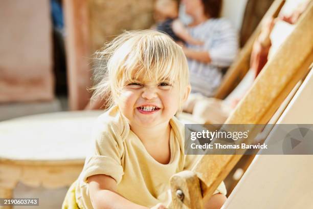medium shot young girl making a face at camera during family vacation - innocence stock pictures, royalty-free photos & images