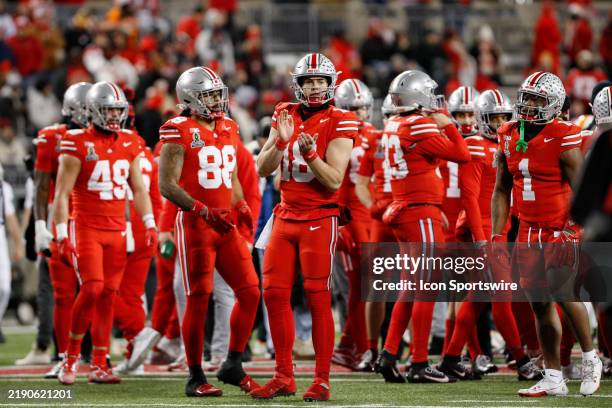 Ohio State Buckeyes quarterback Will Howard warms up with his teammates before the college football playoff first round game against the Tennessee...