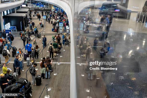 Travelers at the United Airlines check-in area at San Francisco International Airport in San Francisco, California, US, on Monday, Dec. 23, 2024. The...