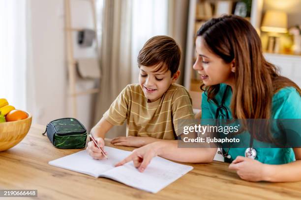 caring nurse supporting pediatric patient during homework session, providing educational assistance with compassionate mentorship - kids problem solving stock pictures, royalty-free photos & images
