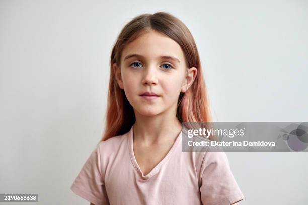 portrait of young girl with dyed pink hair looking at camera - babymeisjes stockfoto's en -beelden