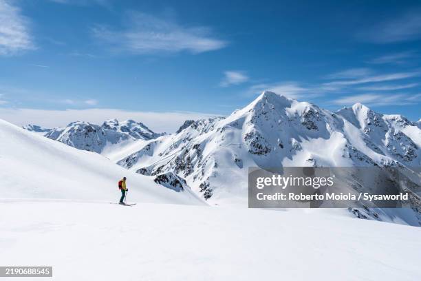 ski mountaineer admiring the winter landscape - livigno stock pictures, royalty-free photos & images