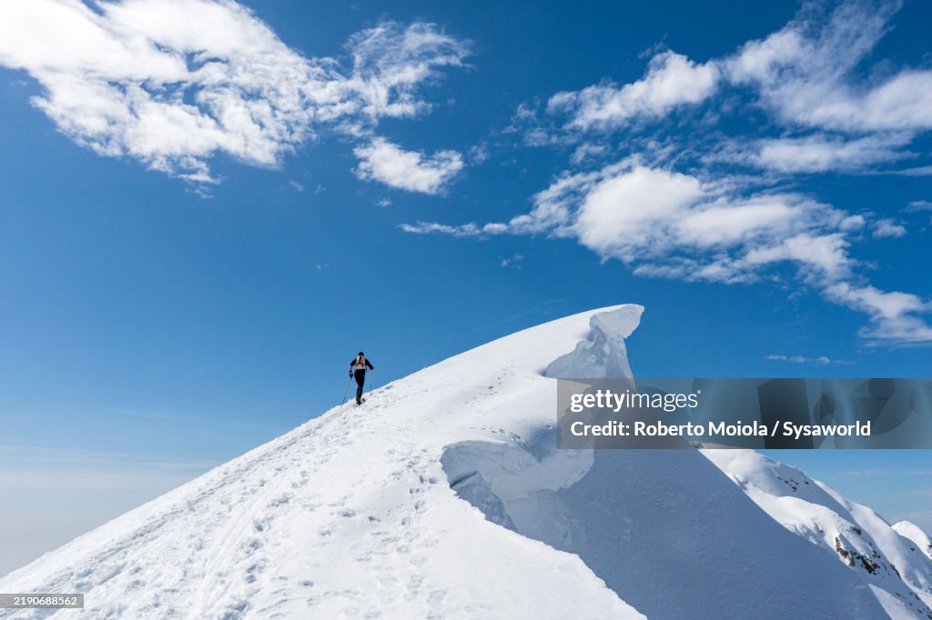 Ski mountaineer on top of Grignone mountain, Italy