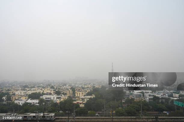 View of skyscrapers engulfed in haze due to rising air pollution in the morning on December 23, 2024 in Noida, India. Parts of Delhi-NCR witnessed...