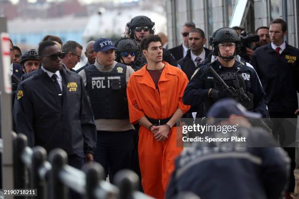 Luigi Mangione, suspect in the killing of UnitedHealthcare CEO Brian Thompson in New York City, arrives at a heliport with members of the NYPD on...