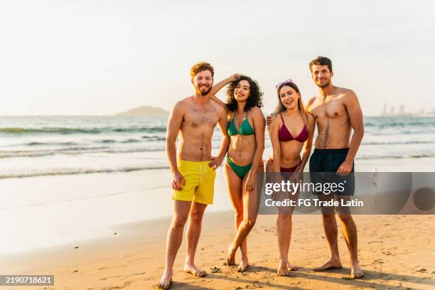 portrait of friends on the beach - swimwear stock pictures, royalty-free photos & images