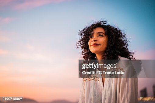Young woman looking at view contemplating outdoors Young woman looking at view contemplating outdoors