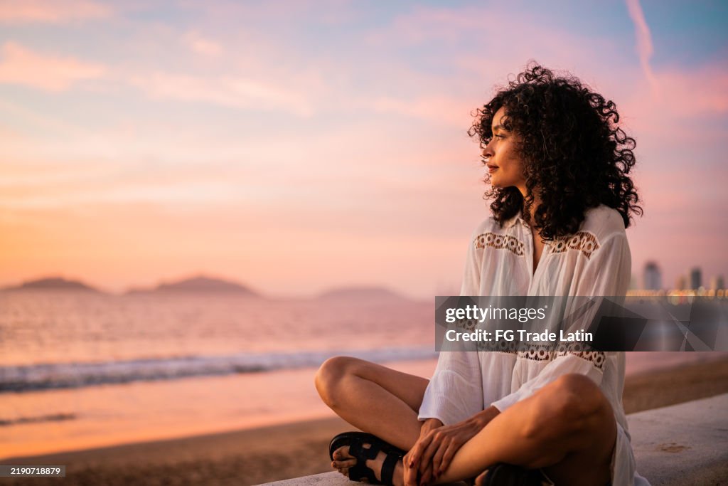 Young woman looking at view contemplating on the beach