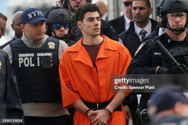 Luigi Mangione, suspect in the killing of UnitedHealthcare CEO Brian Thompson in New York City, arrives at a heliport with members of the NYPD on...