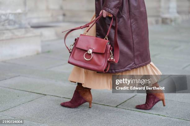 Maria Rosaria Rizzo wears a red leather Gucci bag, brown and burgundy suede L Arianna boots high heels, during a street style fashion photo session,...