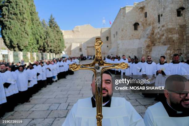 Members of the clergy take part in the yearly Christmas procession led by Latin Patriarch of Jerusalem outside the Church of the Nativity in...