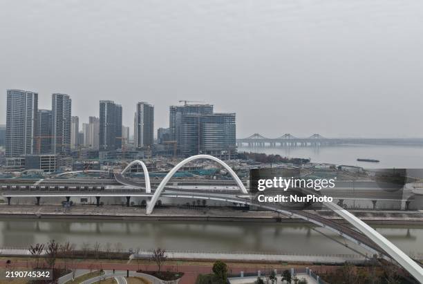 Scenic pedestrian bridge across the Sanbao ship Lock on the Beijing-Hangzhou Grand Canal is seen from the air in Hangzhou, China, on December 25,...