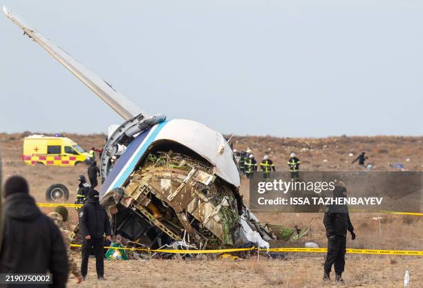 Emergency specialists work at the crash site of an Azerbaijan Airlines passenger jet near the western Kazakh city of Aktau on December 25, 2024.