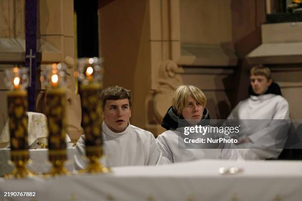 Young men assist during the Christmas Mass at the Roman Catholic Church of St Nicholas in Kyiv, Ukraine, on December 25, 2024. NO USE RUSSIA. NO USE...