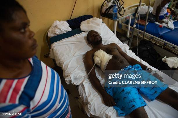 Journalist Reginald Balthazar is treated on December 25, 2024 in hospital after being injured in armed gang violence while covering the reopening of...