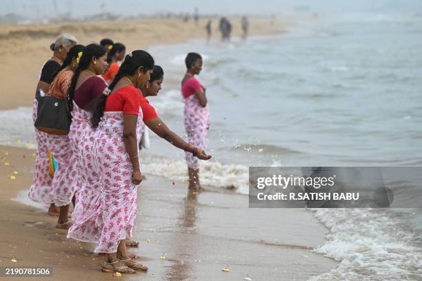 Women perform rituals during a ceremony held on the 20th anniversary for the victims of the 2004 Indian Ocean tsunami, at Pattinapakkam beach in...