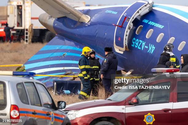 Emergency specialists work at the crash site of an Azerbaijan Airlines passenger jet near the western Kazakh city of Aktau on December 25, 2024. The...