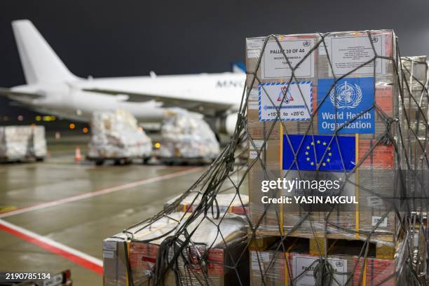 Workers unload medical and health supplies to Syria, delivered by the World Health Organization , at the Istanbul International Airport in Istanbul...