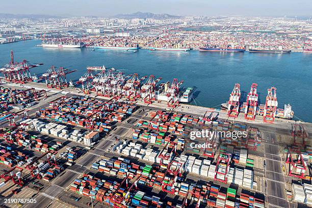 Shipping containers and gantry cranes are seen at Qingdao port in Qingdao, in eastern China's Shandong province on December 26, 2024. / China OUT