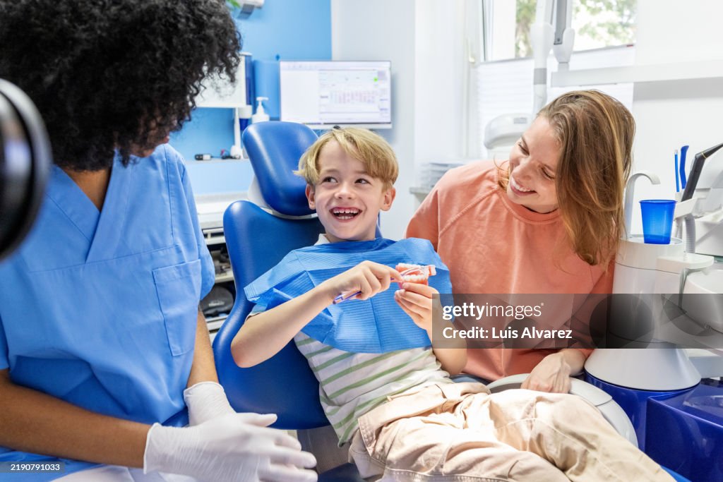 Family engaged in dental hygiene education.