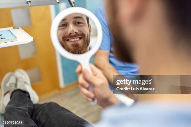 patient smiling after treatment in dental clinic. - implante dentário imagens e fotografias de stock
