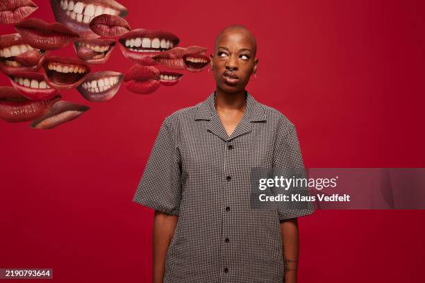 non-binary person looking sideways at mouth expressions - verguenza fotografías e imágenes de stock