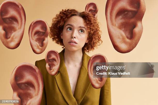 curly haired non-binary person amidst ears cut out - öra bildbanksfoton och bilder