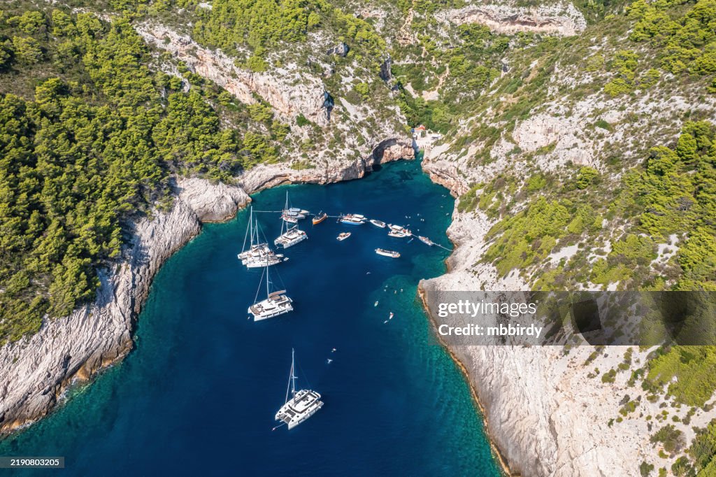 Tourist boats at famous Stiniva cove, Vis island, Dalmatia, Croatia, view from drone