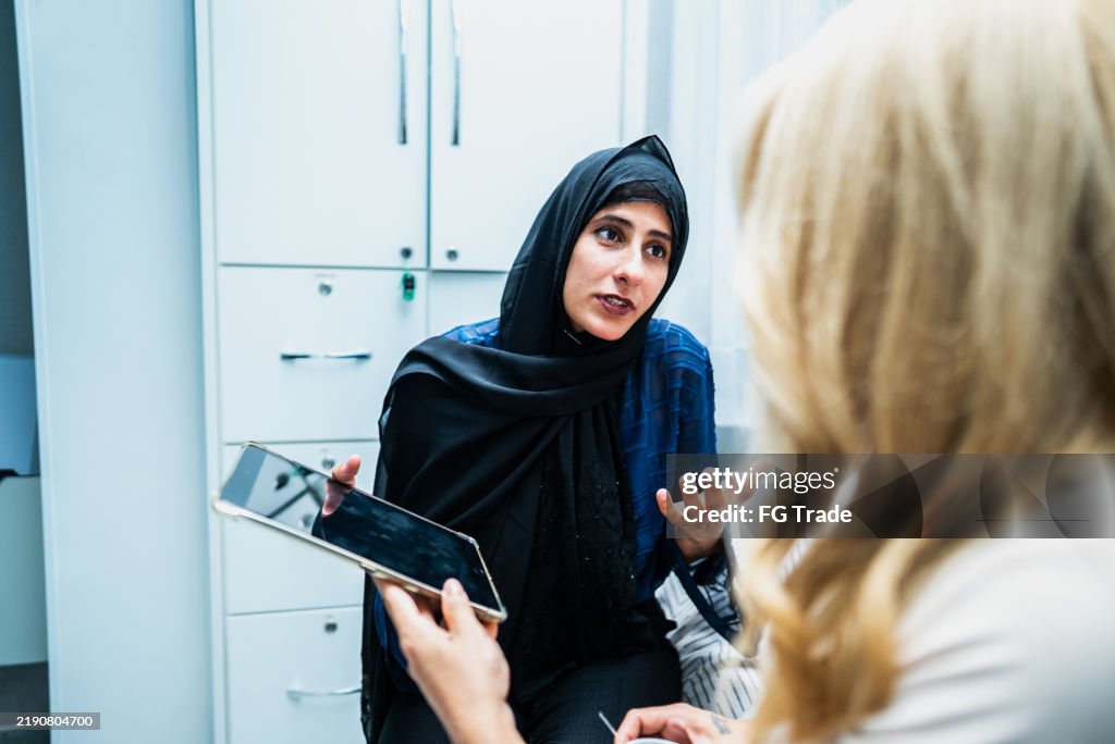 Businesswoman talking with coworker on the office