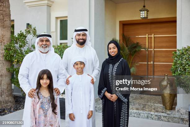 happy arab family standing in front of their house - granddaughter stock pictures, royalty-free photos & images