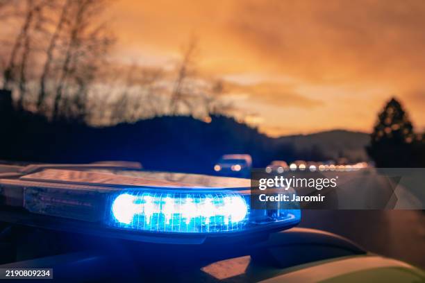 blue flashing light on ambulance car of emergency medical service - cuerpo de policía fotografías e imágenes de stock