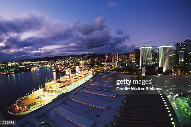 oceanliner & city at night in honolulu, hawaii - cruise liner foto e immagini stock