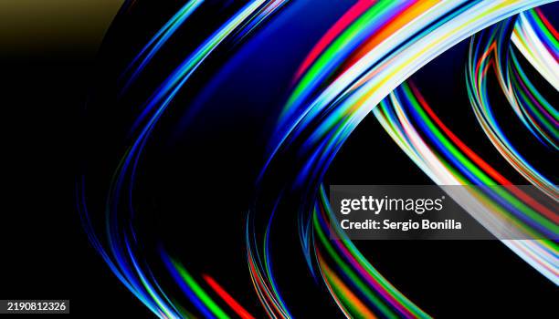 colorful abstract light trails swirl against a dark background - abstract swirl design stock illustrations