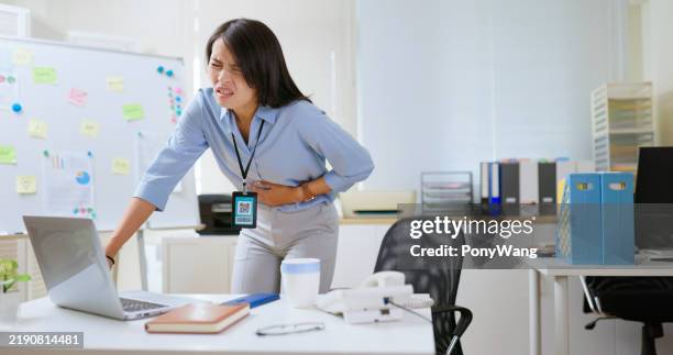 woman suffering stomachache at work - bloating stock pictures, royalty-free photos & images