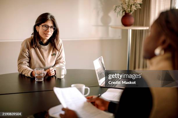 smiling woman with autism spectrum disorder candidate in eyeglasses giving interview - entrevista de trabajo fotografías e imágenes de stock