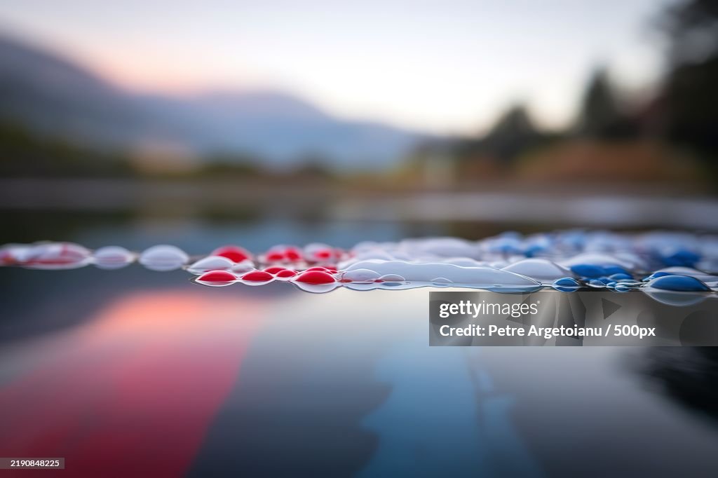 Close-up shot of an abstract background of oil bubbles on the water surface