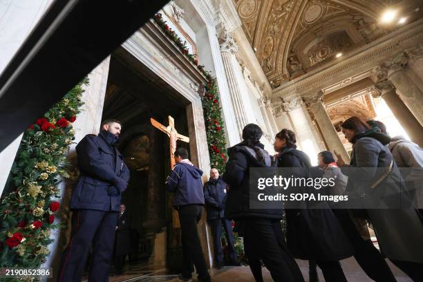 Pilgrims from all over the world perform the ritual of crossing the Holy Door on the first day of opening it by Pope Francis, in St. Peter's Basilica...