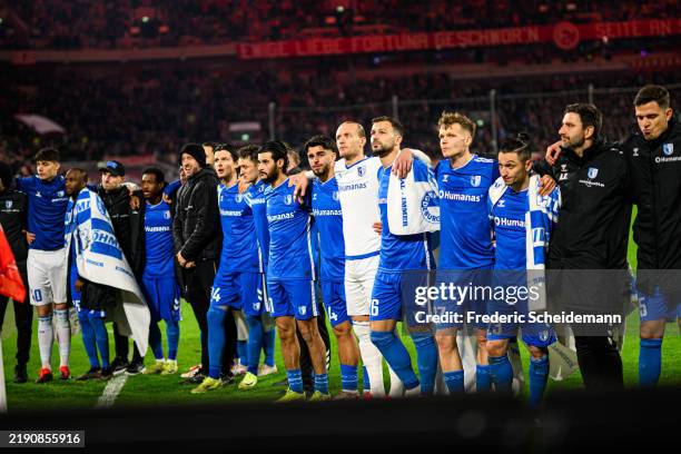 Magdeburg players stand together with their fans during the Second Bundesliga match between Fortuna Düsseldorf and 1. FC Magdeburg at Merkur...