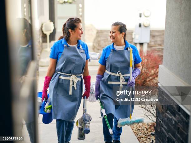 professional housecleaners in a home - maid uniform stock pictures, royalty-free photos & images