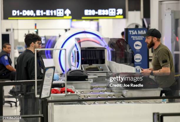 Travelers go through a TSA Pre checkpoint at the Miami International Airport as some of the year's busiest travel days occur during the holiday...