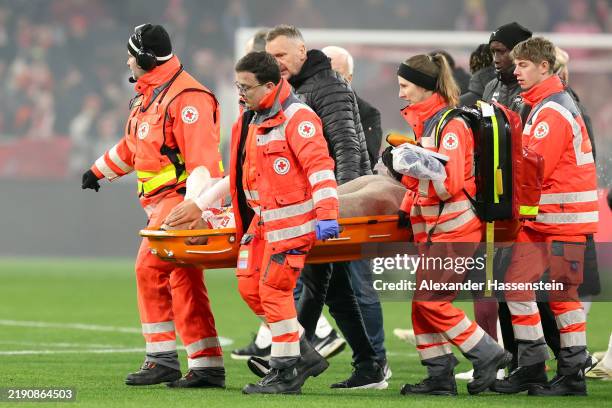 Benjamin Henrichs of RB Leipzig being attended by the medical assistance during the Bundesliga match between FC Bayern München and RB Leipzig at...