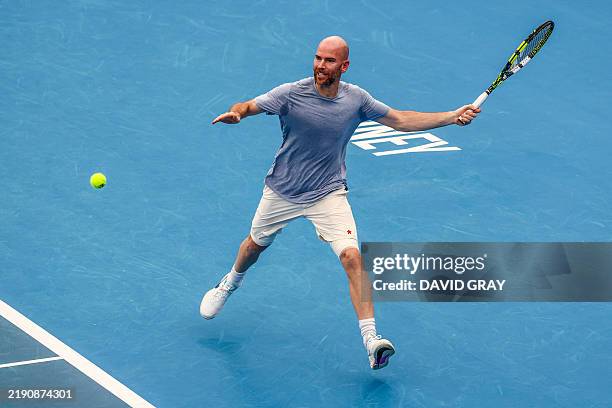 France's Adrian Mannarino hits a return to compatriot Ugo Humbert during a practice session on Ken Rosewall Arena in Sydney on December 27 ahead of...