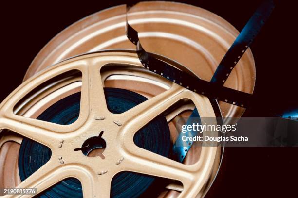 reel of film on a black background - 8mm film projector stock pictures, royalty-free photos & images