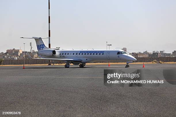 S World Food Program plane is pictured parked at Sanaa international airport on December 27 following Israeli strikes at the site the previous day....